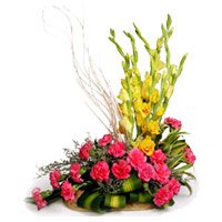 Deliver Online 18 Pink Carnation 6 Yellow Glad Flower Basket with 2 Free Rakhi to India