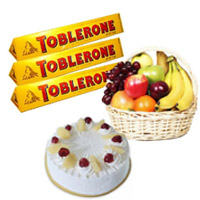 Buy 500 gm Pineapple Cake with 1 Kg Fresh Fruits Basket and Toblerone Chocolates (300 gm) Delivery in India